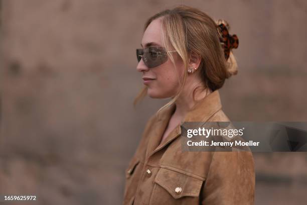 Sonia Lyson seen wearing Miu Miu brown transparent sunglasses, Miu Miu brown suede leather jacket and a brown tortoise hair clip, on September 03,...