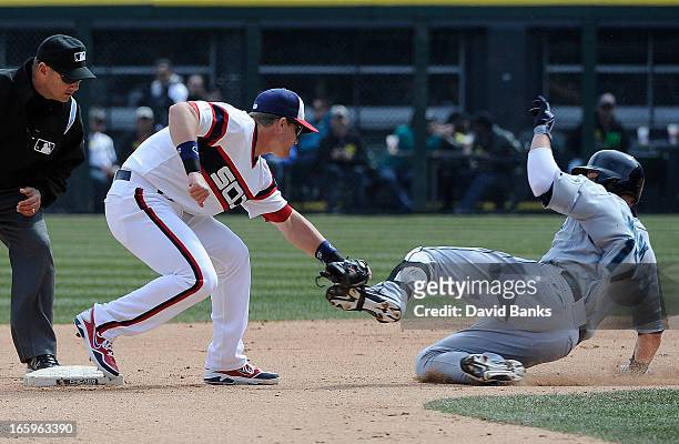 Gordon Beckham of the Chicago White Sox tags out Justin Smoak of the Seattle Mariners at second base in the seventh inning on April 7, 2013 at U.S....