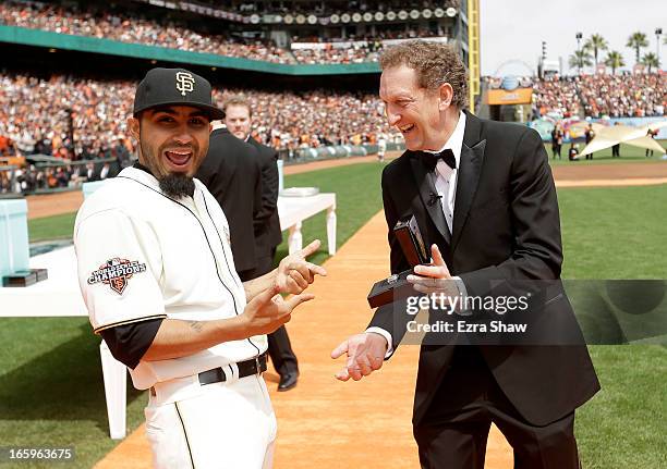 San Francisco Giants President and Chief Executive Officer Larry Baer gives Sergio Romo his 2012 Championship Ring during a pregame ceremony honoring...