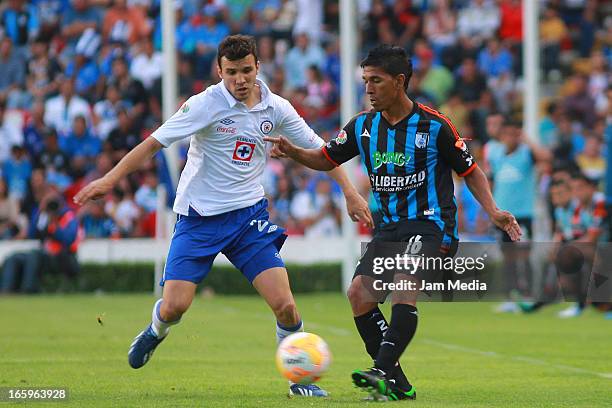 Juan Carlos Marino of Queretaro struggles for the ball with Mariano Pavone of Cruz Azul during the Clausura 2013 Liga MX at La Corregidora Stadium on...