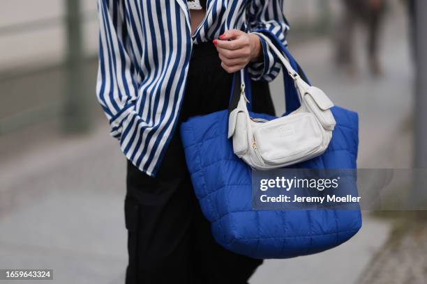 Sonia Lyson seen wearing Zara blue / white striped blouse, Adidas black jogger cargo pants, Miu Miu black / white knit crochet bra, Miu Miu Wandler...