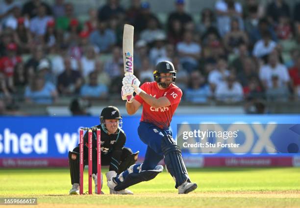 New Zealand wicketkeeper Tim Seifert looks on as England batsman Dawid Malan plays a shot during the 3rd Vitality T20I between England and New...