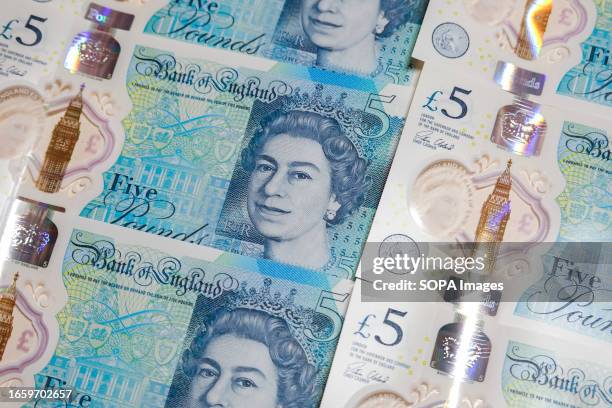In this photo illustration, some 5 pounds banknotes with Queen Elizabeth II are displayed on a table.