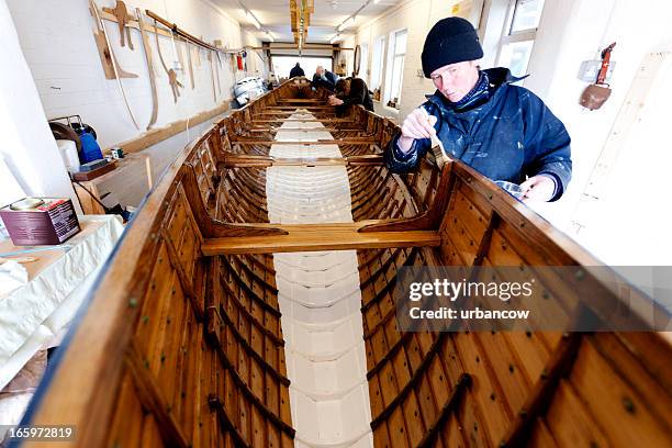 team varnishing a gig boat - shipbuilder stock pictures, royalty-free photos & images