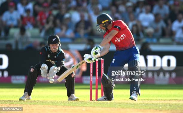 New Zealand wicketkeeper Tim Seifert looks on as England batsman Jos Buttler hits out during the 3rd Vitality T20I between England and New Zealand at...