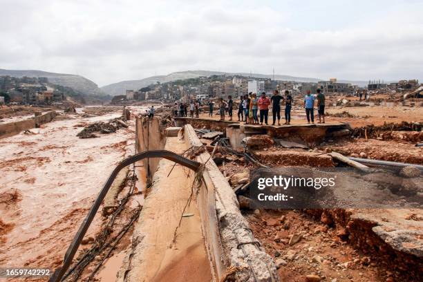 People look at the damage caused by freak floods in Derna, eastern Libya, on September 11, 2023. Flash floods in eastern Libya killed more than 2,300...