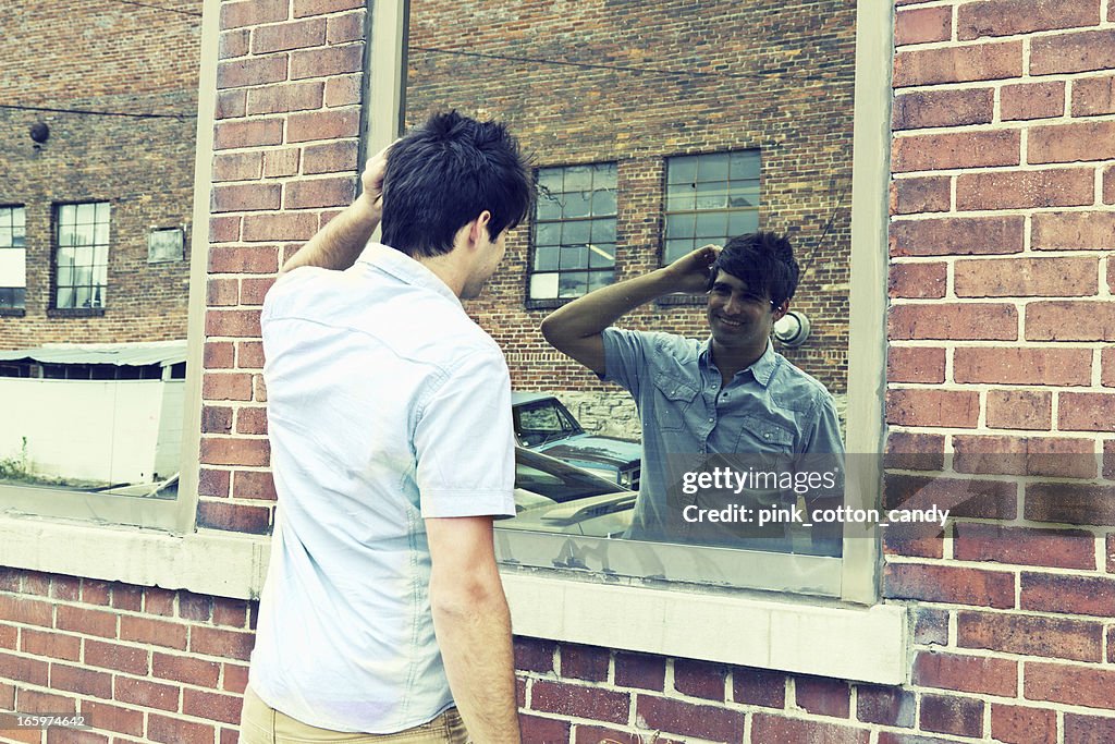 Man Pleased with His Appearance in Front of Window