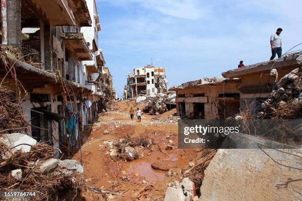 People check an area damaged by flash floods in Derna, eastern Libya, on September 11, 2023. Flash floods in eastern Libya killed more than 2,300...