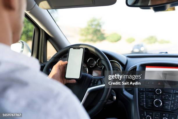man using cell phone while driving. - distracted driver stock pictures, royalty-free photos & images