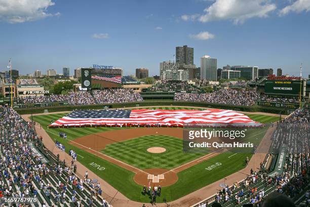 General view of Wrigley Field as the American flag is seen during the national anthem before the game between the Chicago Cubs and the San Francisco...