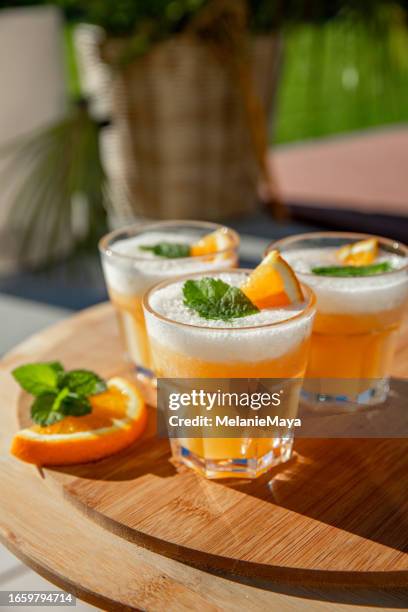 frozen cocktail spritz aperitif drink with orange slices and mint on outdoor table - tropical cocktail stock pictures, royalty-free photos & images