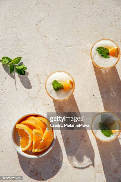 frozen cocktail spritz aperitif drink with orange slices and mint on stone table - slush ice stock pictures, royalty-free photos & images