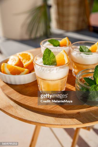 frozen cocktail spritz aperitif drink with orange slices and mint on outdoor table - slush stock pictures, royalty-free photos & images