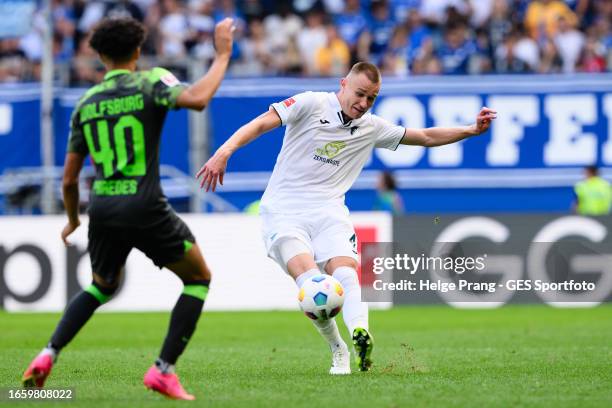 Attila Szalai of Hoffenheim battles for possession with Kevin Paredes of Wolfsburg during the Bundesliga match between TSG Hoffenheim and VfL...