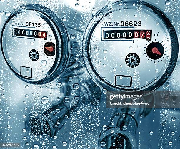 new water counter / meter behind a wet window - machine valve stock pictures, royalty-free photos & images