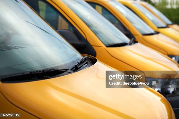 vans / transporters in a row - fleet cars stock pictures, royalty-free photos & images