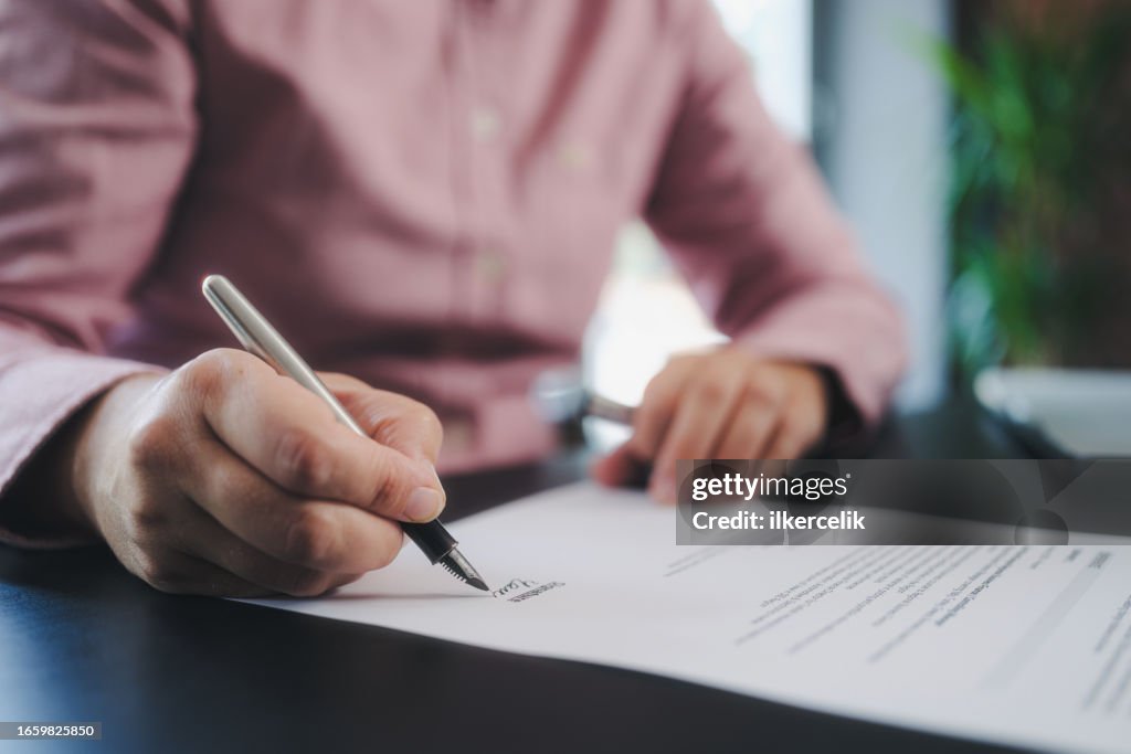 Businesswoman signing an official document
