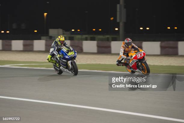 Marc Marquez of Spain and Repsol Honda Team leads Valentino Rossi of Italy and Yamaha Factory Racing during the MotoGP race of the MotoGp of Qatar at...