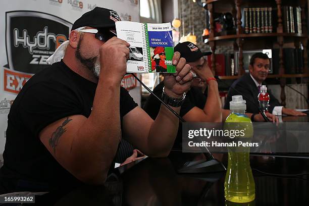 Francois Botha of South Africa holds up a drug free sport handbook during a press conference with New Zealand boxer Joseph Parker at the Northern...