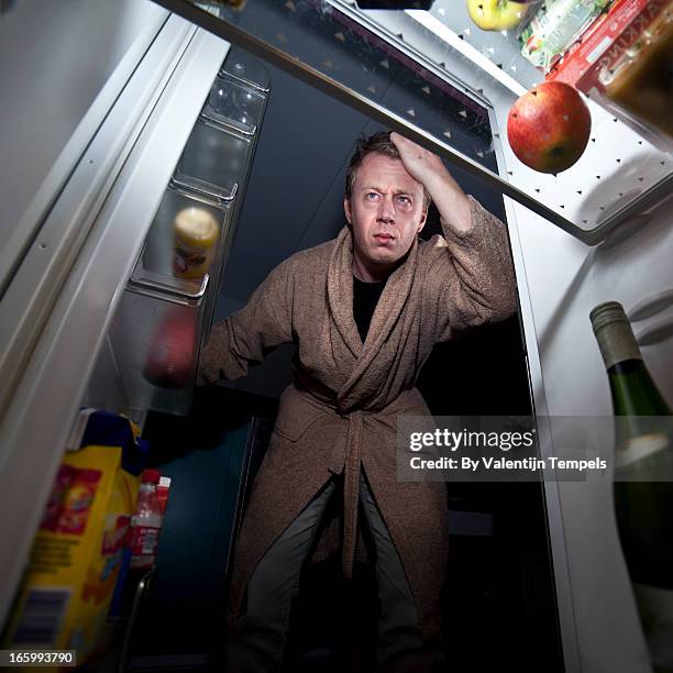 man looks into fridge - inside fridge stockfoto's en -beelden