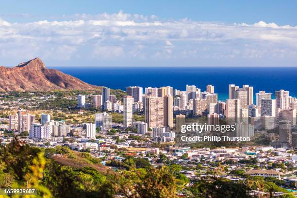 mountain view of waikiki beach cityscape on a sunny afternoon with the pacific ocean in the background - honolulu stock pictures, royalty-free photos & images