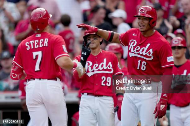 Spencer Steer, TJ Friedl, and Noelvi Marte of the Cincinnati Reds celebrate after Steer hit a home run in the second inning against the Seattle...