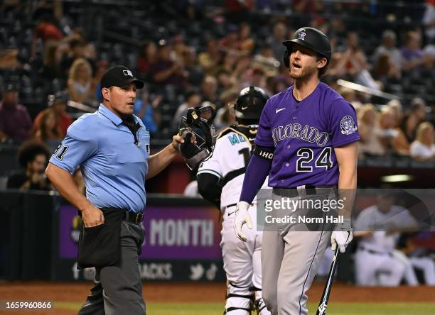 Ryan McMahon of the Colorado Rockies reacts after being called out on strikes by home plate umpire Quinn Wolcott during the fourth inning against the...