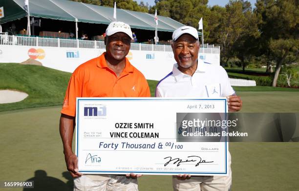 Former MLB players Vince Coleman and Ozzie Smith pose with a check for $40,000 USD after winning ARIA Resort & Casino's Michael Jordan Celebrtiy...