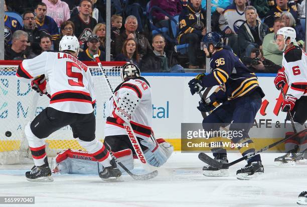 Patrick Kaleta of the Buffalo Sabres scores a first period goal past Martin Brodeur and Adam Larsson of the New Jersey Devils on April 7, 2013 at the...