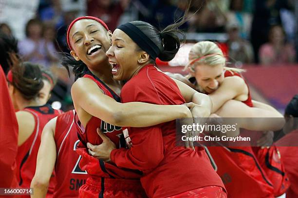 Members of the Louisville Cardnials celebrate after defeating the California Golden Bears 64-57 to advance to the final roundduring the National...