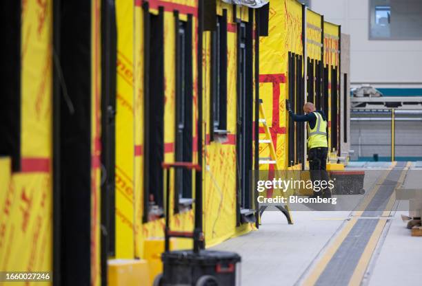 An employee checks a window frame in a modular house at the Tophat factory in Foston near Derby, UK, on Tuesday, Sept. 12, 2023. Persimmon Plc and...