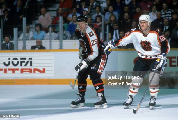 Brett Hull of the Campbell Conference and the St. Louis Blues defends against Glen Wesley of the Wales Conference and the Montreal Canadiens during...