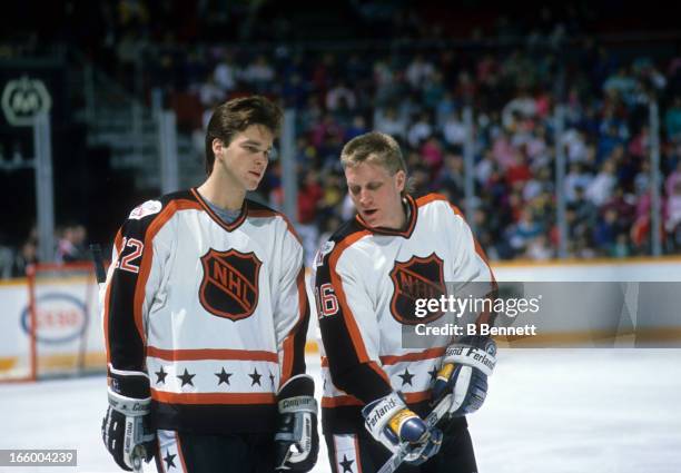 Brett Hull of the Campbell Conference and the St. Louis Blues talks with teammate Luc Robitaille of the Los Angeles Kings during the 1989 40th NHL...