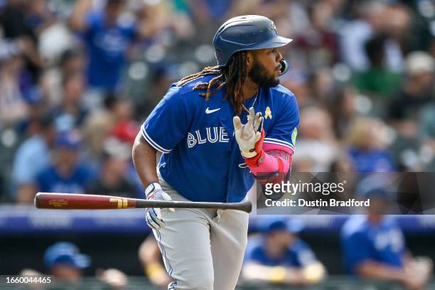 Vladimir Guerrero Jr. #27 of the Toronto Blue Jays watches the flight of the ball after hitting a fifth inning RBI single against the Colorado...