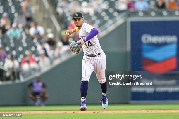 Ezequiel Tovar of the Colorado Rockies throws to first base after fielding a ground ball against the Toronto Blue Jays in the eighth inning at Coors...