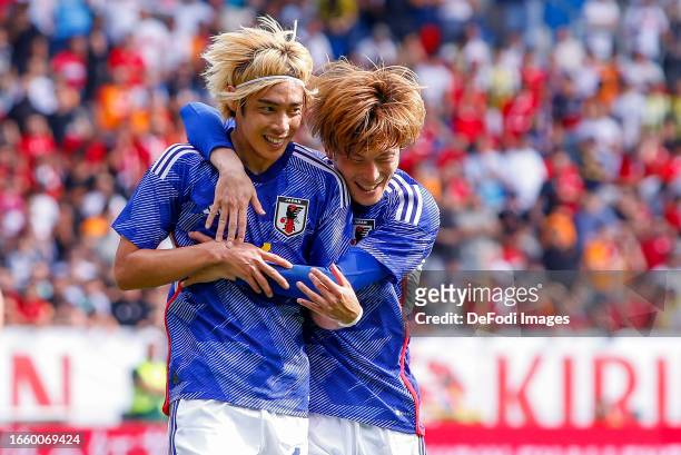 Junya Ito of Japan and Kyogo Furuhashi of Japan celebrates after scoring his teams 4:2 goal with team mates during the international friendly between...