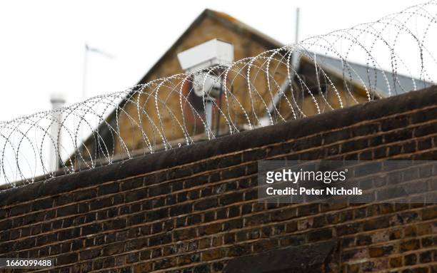 Razor wire and a security camera is seen at HMP Wandsworth on September 12, 2023 in London, England. HMP Wandsworth is a category B men's prison and...