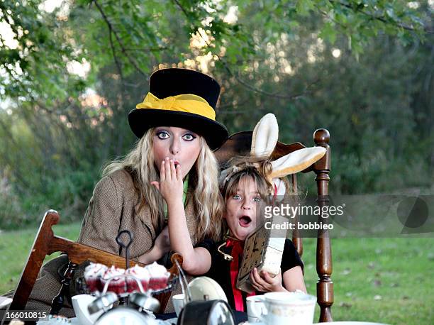march hare and mad hatter costume with clocks - mad hatter stock pictures, royalty-free photos & images