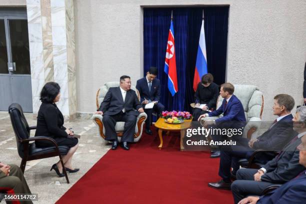 North Korea's leader Kim Jong Un is welcomed by Russian Minister of Natural Resources and Ecology Alexander Kozlov after arriving at the North...
