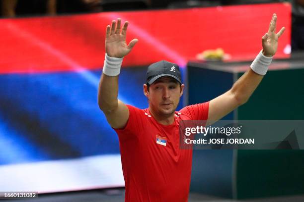 Serbia's Dusan Lajovic celebrates beating South Korea's Hong Seong-chan during the group stage men's singles match between Serbia and South Korea of...