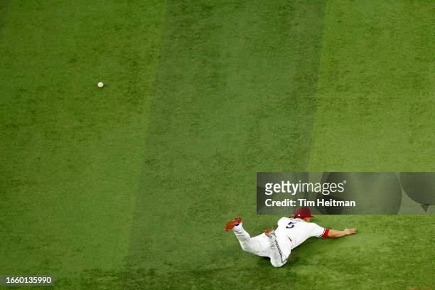 Corey Seager of the Texas Rangers dives trying to field a ground ball in the fifth inning against the Houston Astros at Globe Life Field on September...