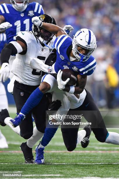 Jacksonville Jaguars Safety Rayshawn Jenkins tackles Indianapolis Colts Wide Receiver Josh Downs during the NFL game between the Jacksonville Jaguars...