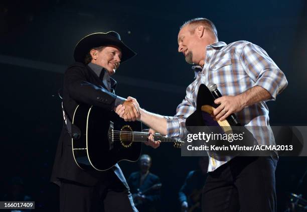 Musicians George Strait and Garth Brooks perform onstage during the 48th Annual Academy of Country Music Awards at the MGM Grand Garden Arena on...