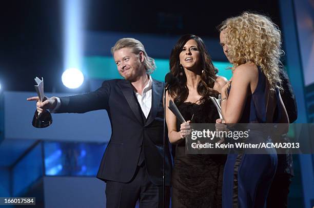 Singers Phillip Sweet, Karen Fairchild, Jimi Westbrook, and Kimberly Schlapman of Little Big Town accept the Vocal Group of the Year award onstage...