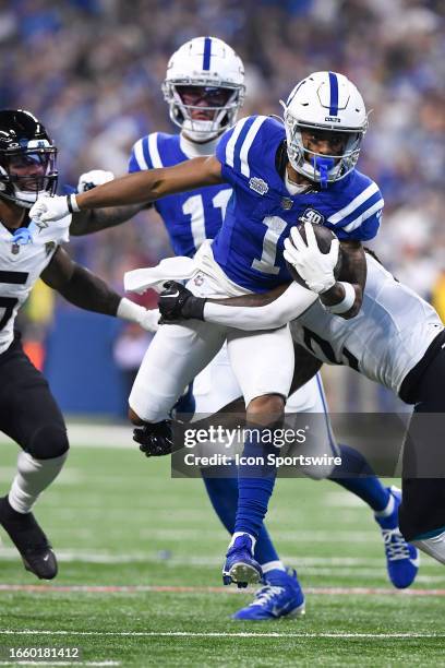 Jacksonville Jaguars Safety Rayshawn Jenkins tackles Indianapolis Colts Wide Receiver Josh Downs during the NFL game between the Jacksonville Jaguars...