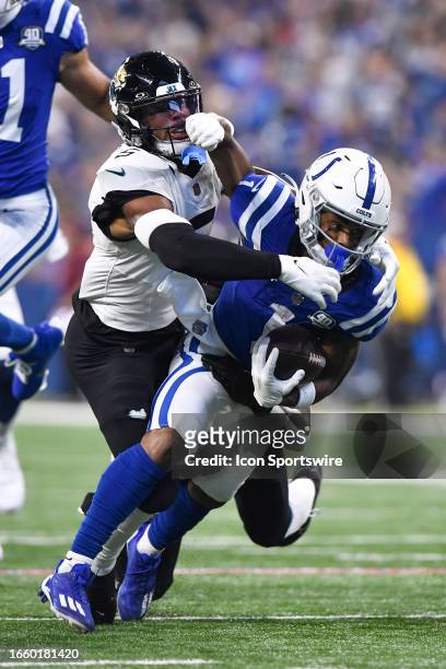 Jacksonville Jaguars Safety Rayshawn Jenkins tackles Indianapolis Colts Wide Receiver Josh Downs during the NFL game between the Jacksonville Jaguars...