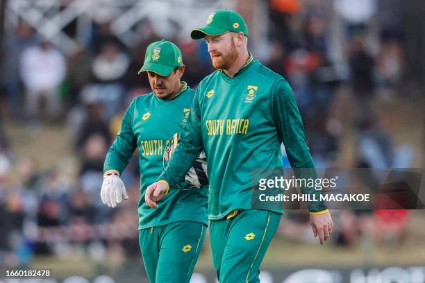 South Africa's Heinrich Klaasen and South Africa's Quinton de Kock walk on the field during the third one-day international cricket match between...