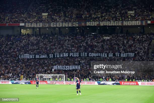 Olympique Lyonnais fans display banners bearing the message; "Laurent Blanc, if you no longer have the balls to fight, give in your notice" during...