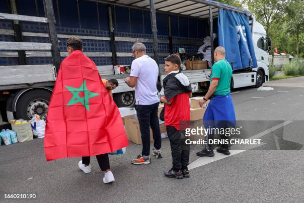 Moroccan football fans donate items for the victims of the earthquake in Morocco at a collection point on the sidelines of the international friendly...