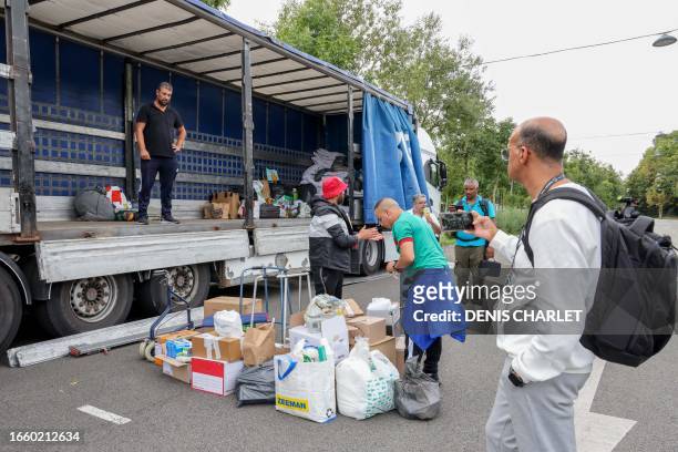Volunteers process donations for the victims of the earthquake in Morocco at a collection point on the sidelines of the international friendly...